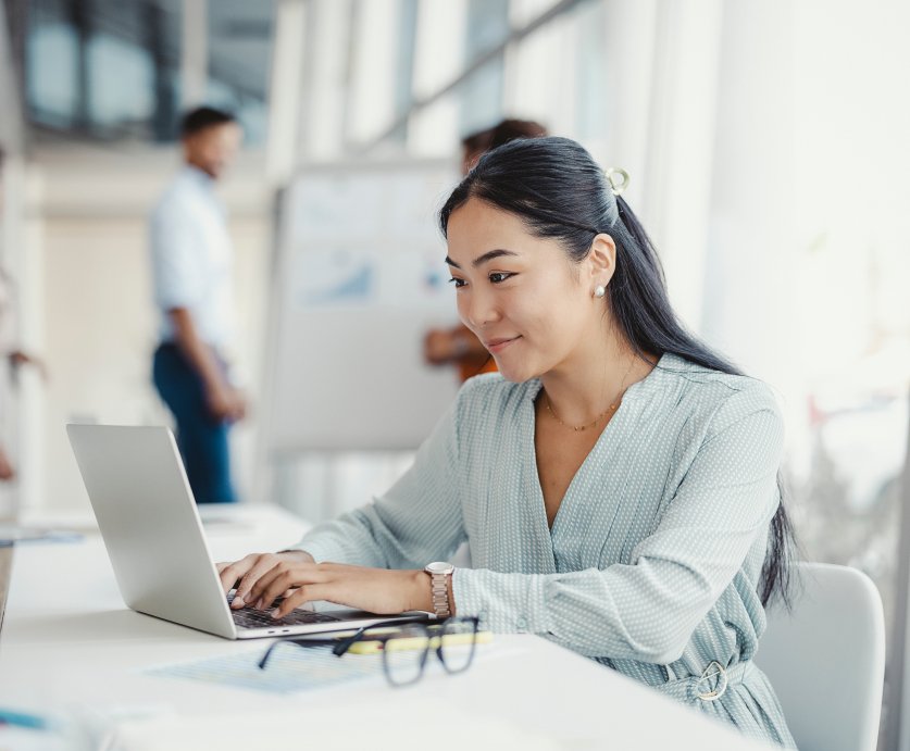 Woman on laptop in a business setting